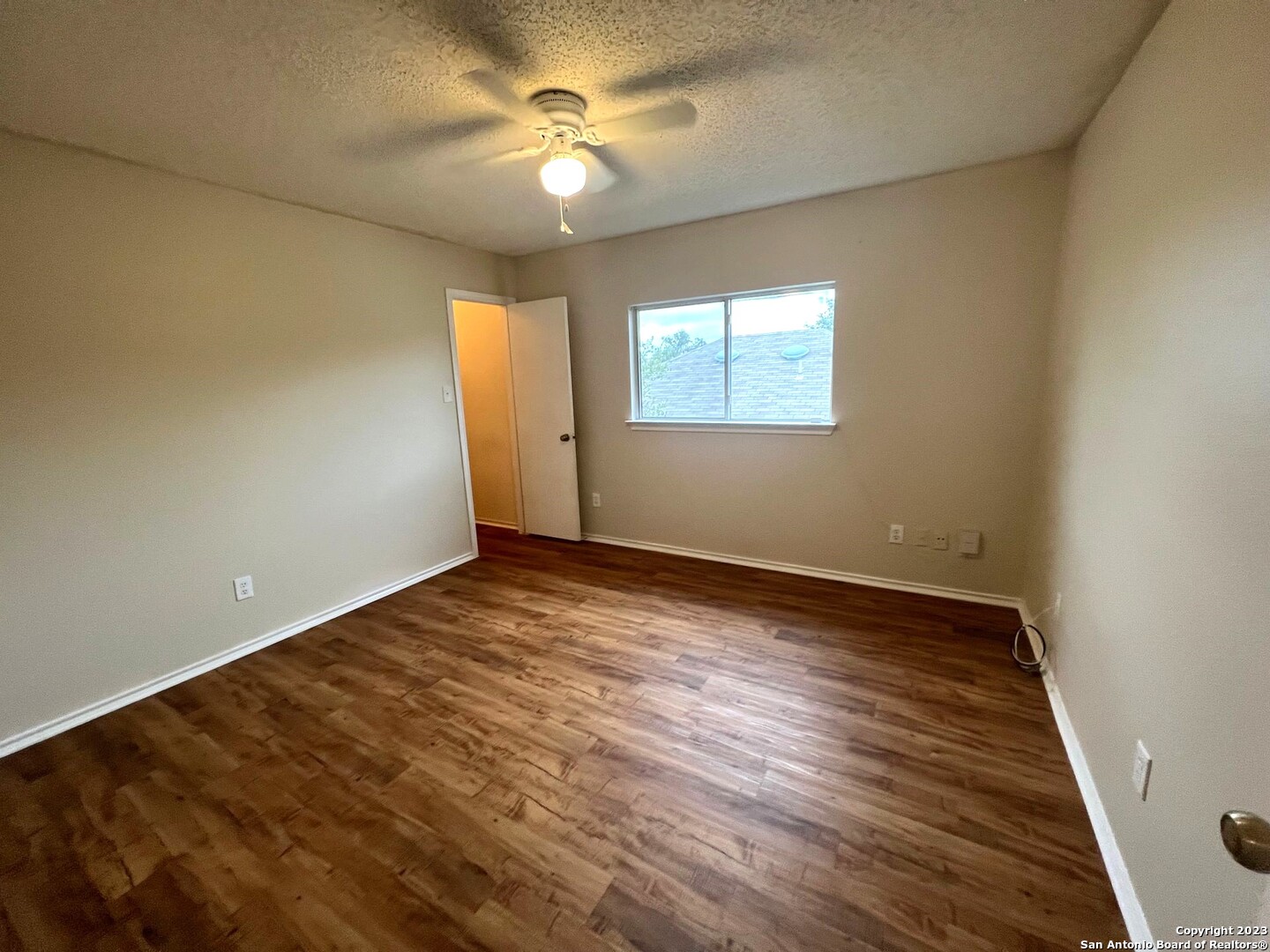 8615 Cross Spring San Antonio, TX 78251 - Photo 10 of 15 an empty room with wooden floor fan and windows