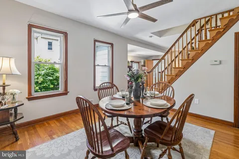 a dining room with furniture a window and wooden floor