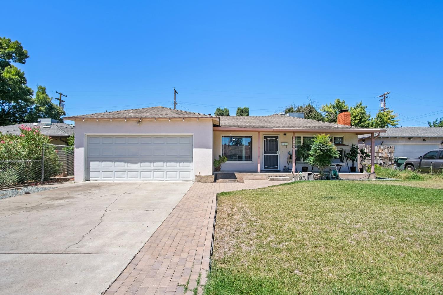 1725 Bronson Avenue Modesto, CA 95350 - Photo 1 of 17 a front view of house with a garden and patio