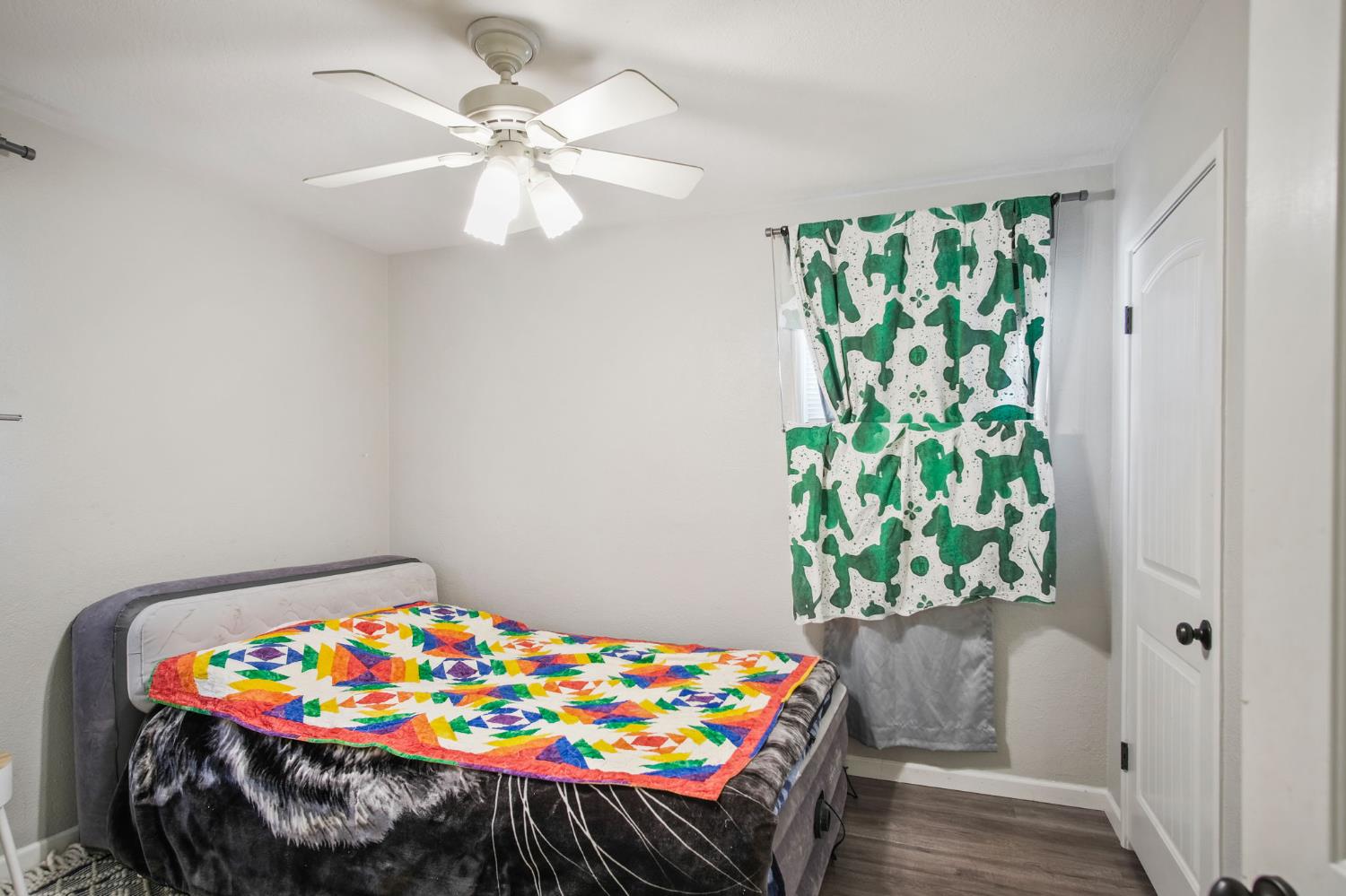 1725 Bronson Avenue Modesto, CA 95350 - Photo 11 of 17 a bed sitting in a bedroom next to a window