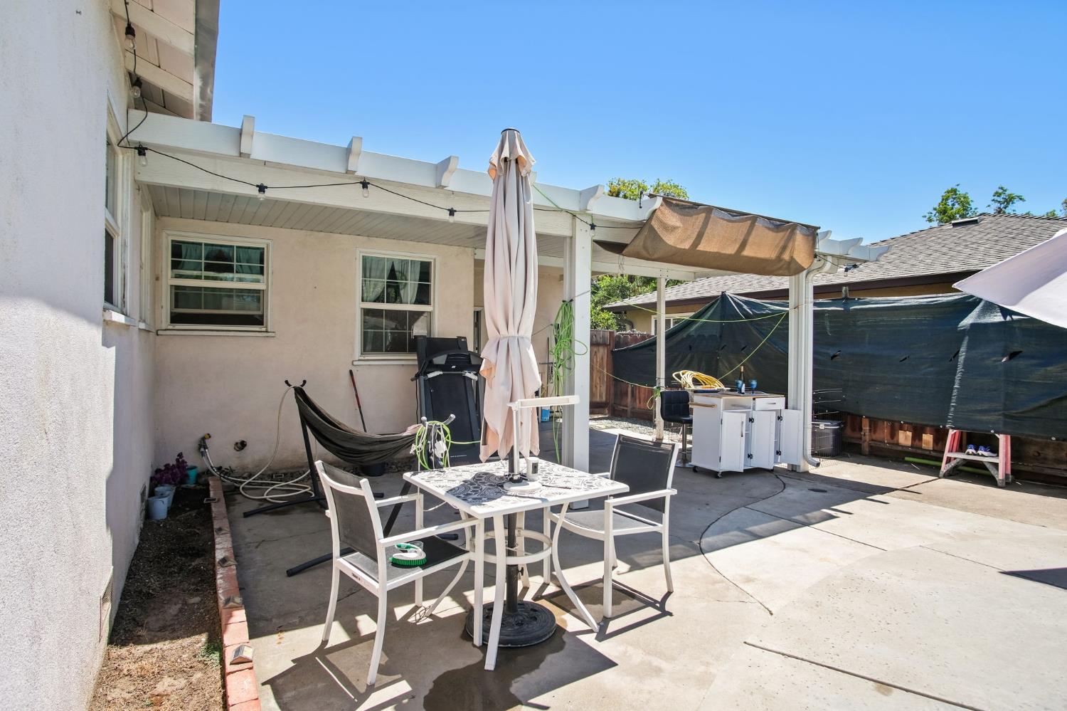 1725 Bronson Avenue Modesto, CA 95350 - Photo 17 of 17 a view of a patio with table and chairs and potted plants