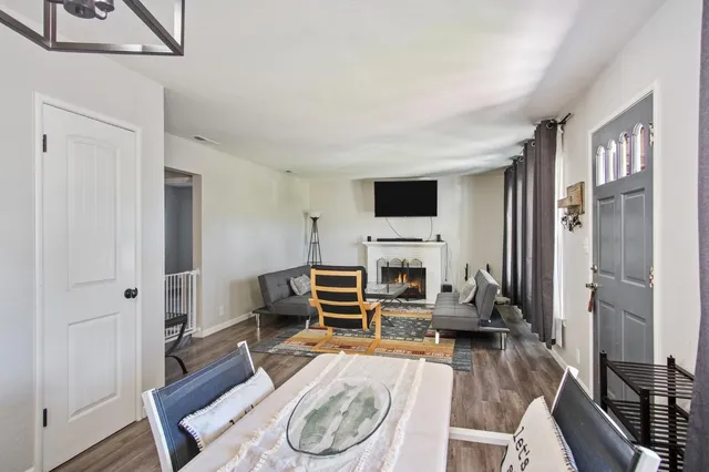 a living room with furniture a fireplace and a flat screen tv