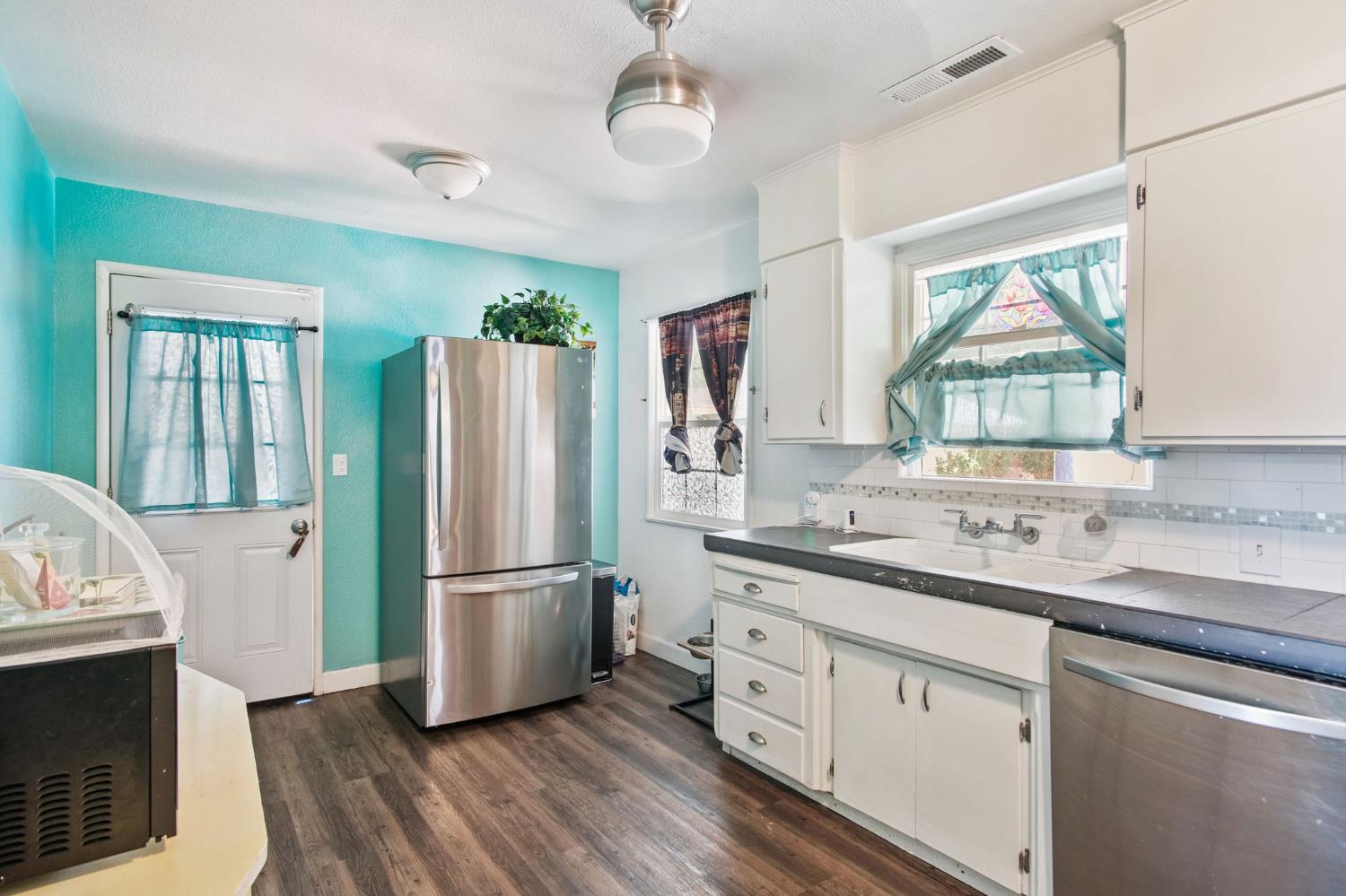 1725 Bronson Avenue Modesto, CA 95350 - Photo 7 of 17 a kitchen with a refrigerator a sink and a stove