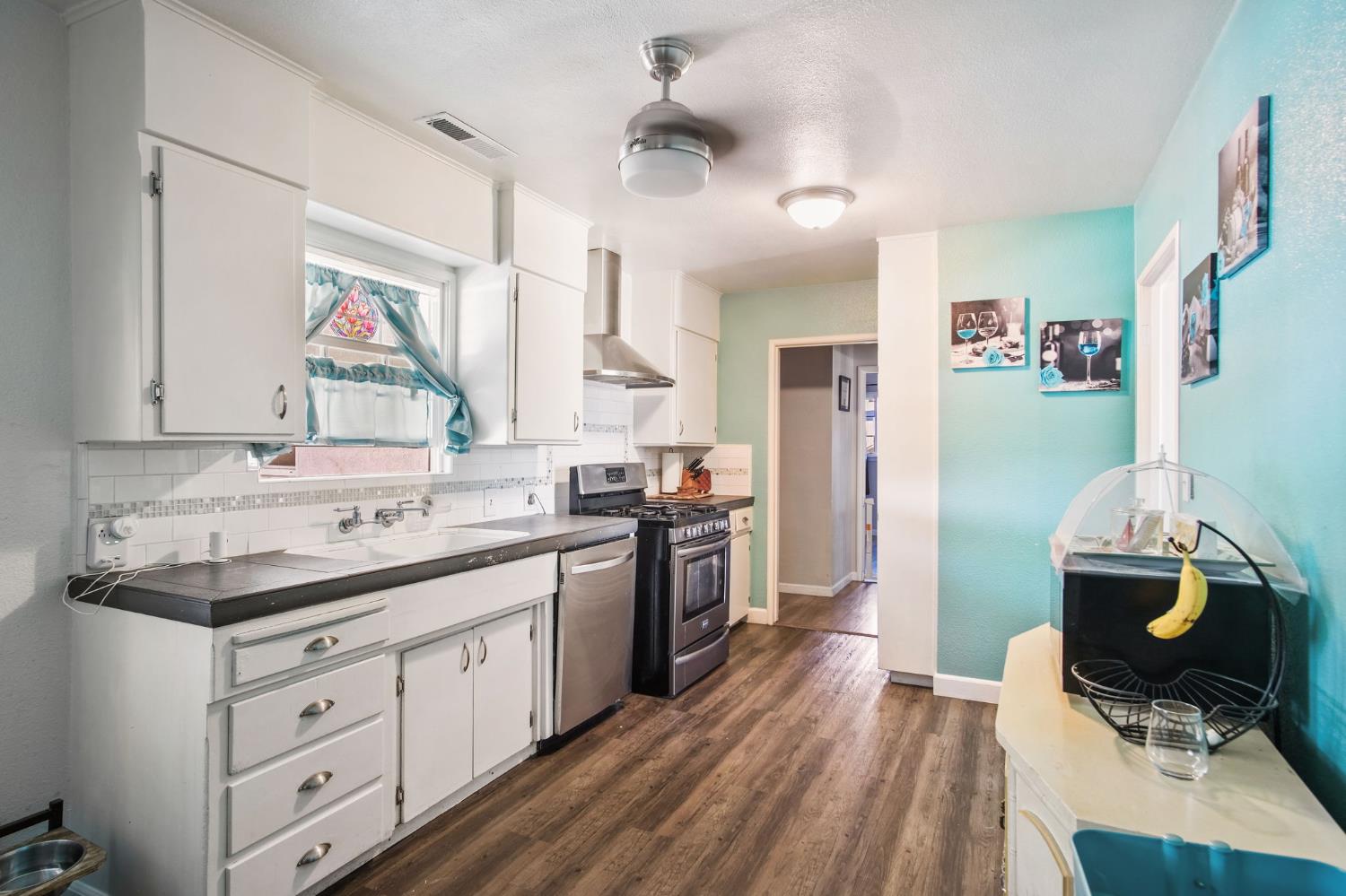 1725 Bronson Avenue Modesto, CA 95350 - Photo 8 of 17 a bathroom with a sink a toilet a mirror and shower