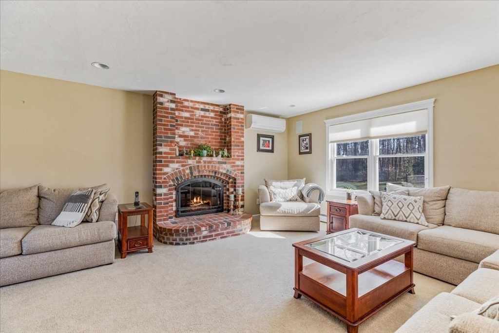 14 Robinson Road Rochester, MA 02770 - Photo 11 of 42 a living room with furniture a fireplace and a large window