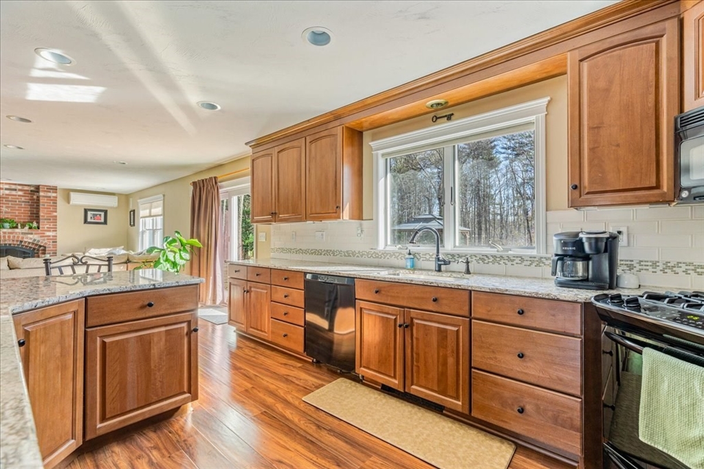 14 Robinson Road Rochester, MA 02770 - Photo 3 of 42 a kitchen with stainless steel appliances granite countertop a stove and white cabinets