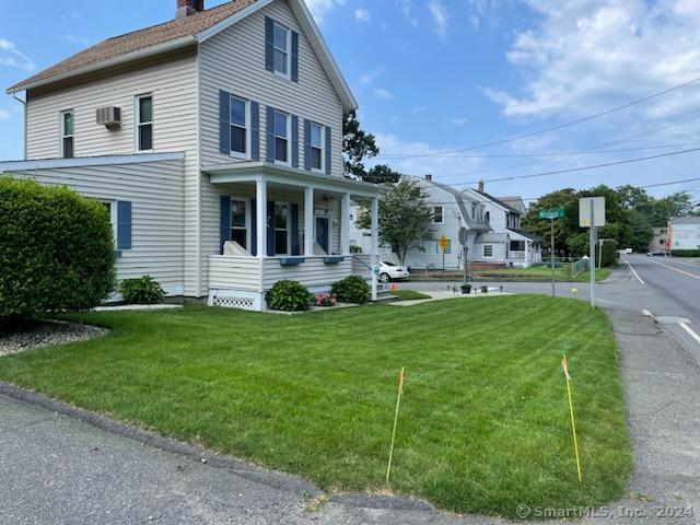 a front view of house with yard and green space