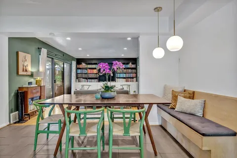 a view of a dining room with furniture and a large window