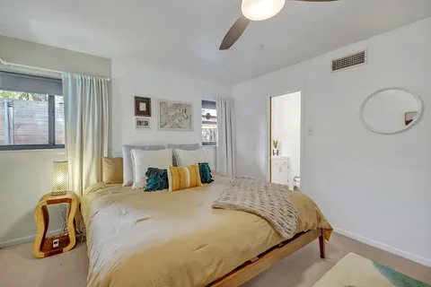 a bedroom with a bed and a painting on the wall