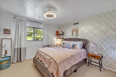a bedroom with a bed and a lamp