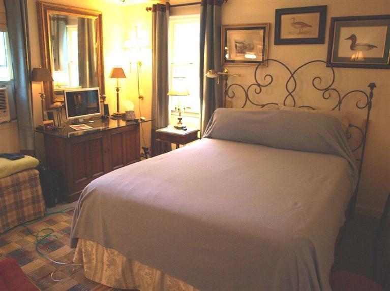 86 Shore Road, Unit 15 Truro, MA 02666 - Photo 21 of 23 a bedroom with a bed and a large window
