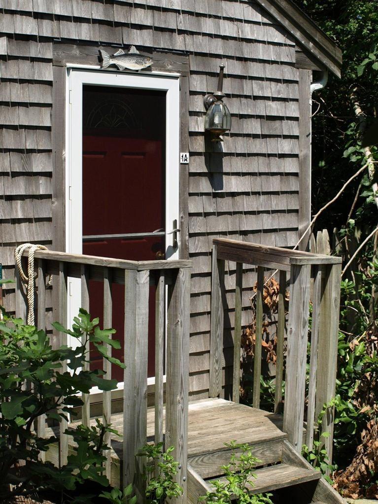 86 Shore Road, Unit 15 Truro, MA 02666 - Photo 10 of 23 a front view of a house with street