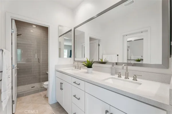 a bathroom with a granite countertop sink mirror and shower