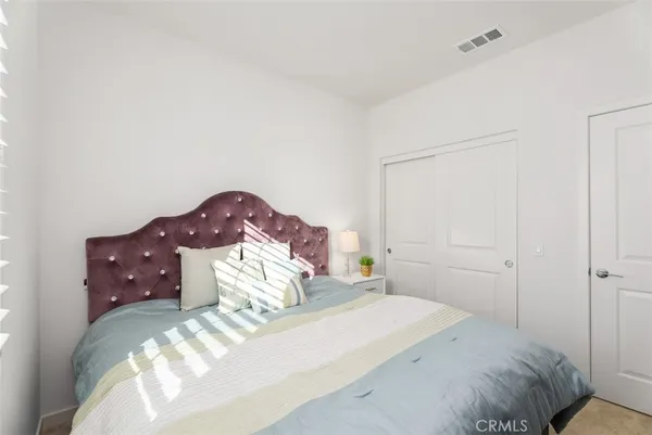 a bedroom with a bed and a painting on the wall