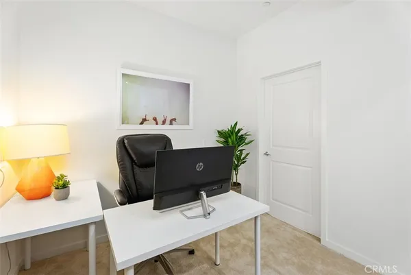 a view of a workspace with furniture