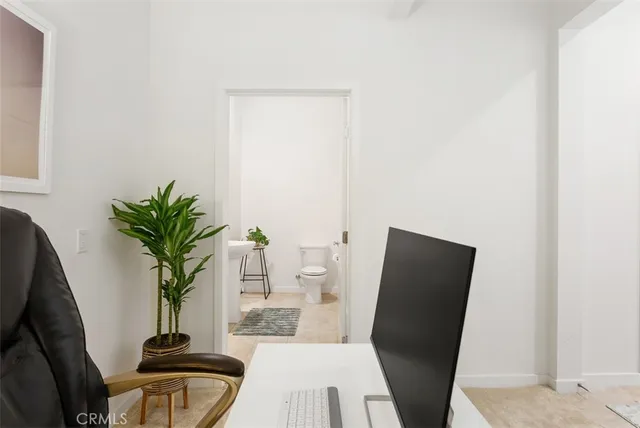 a view of a workspace with furniture and wooden floor