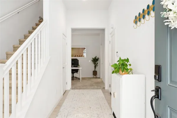 a view of an entryway with wooden floor