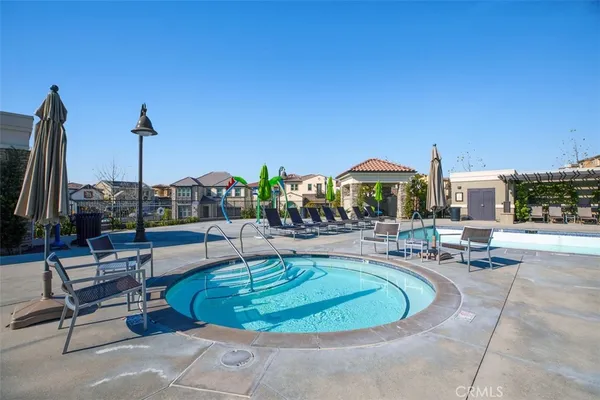 a view of a swimming pool with outdoor seating