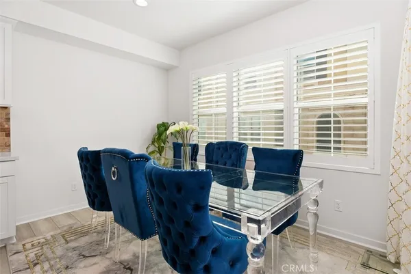 a view of a dining room with furniture and a window