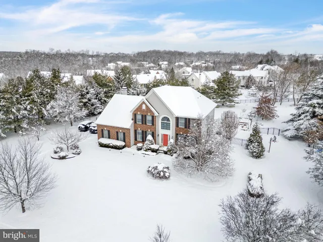 an aerial view of a house with a garden and lake view