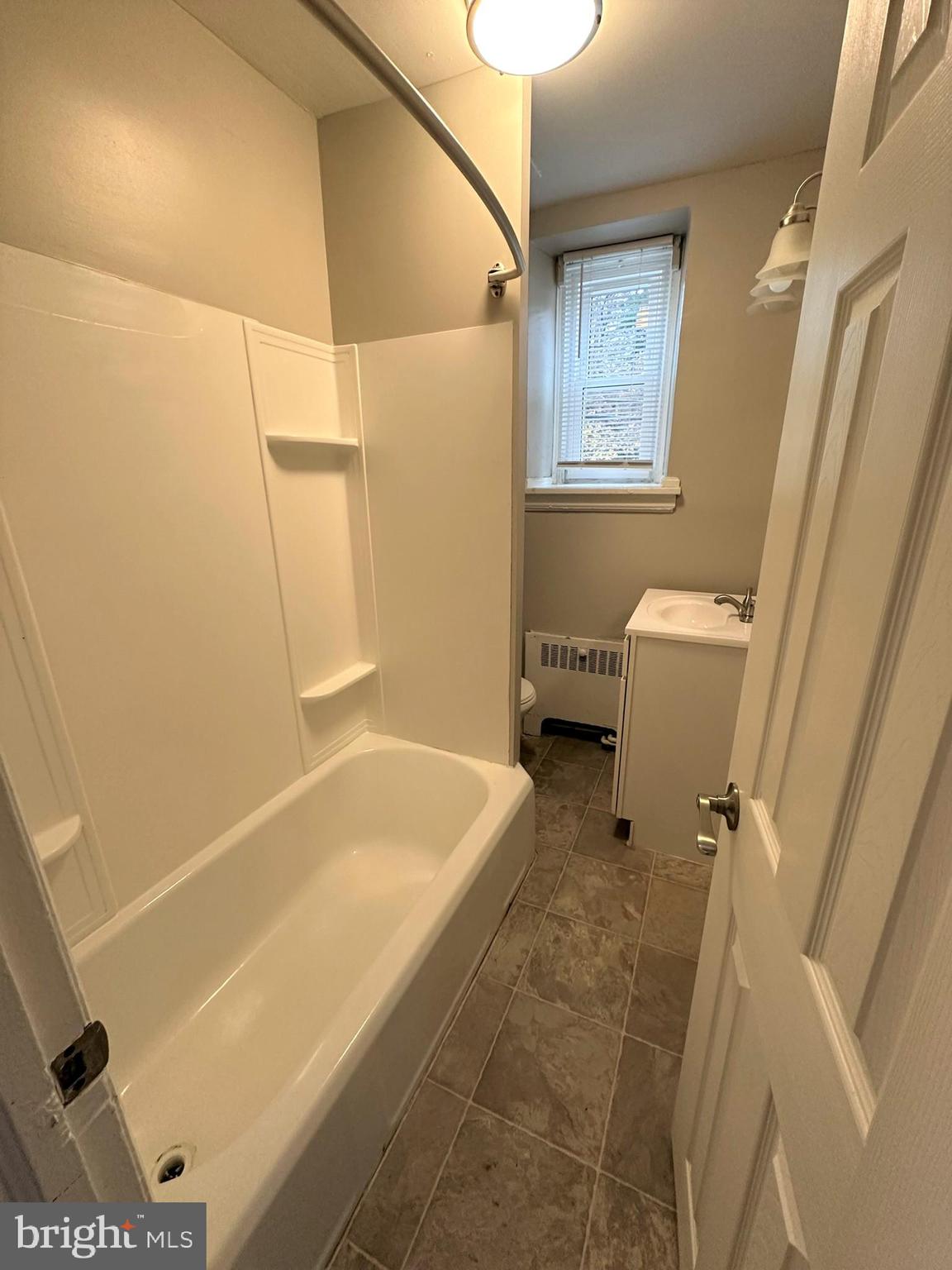 4927 Wynnefield Avenue, Unit 17A Philadelphia, PA 19131 - Photo 23 of 24 a bathroom with a tub a sink and a shower
