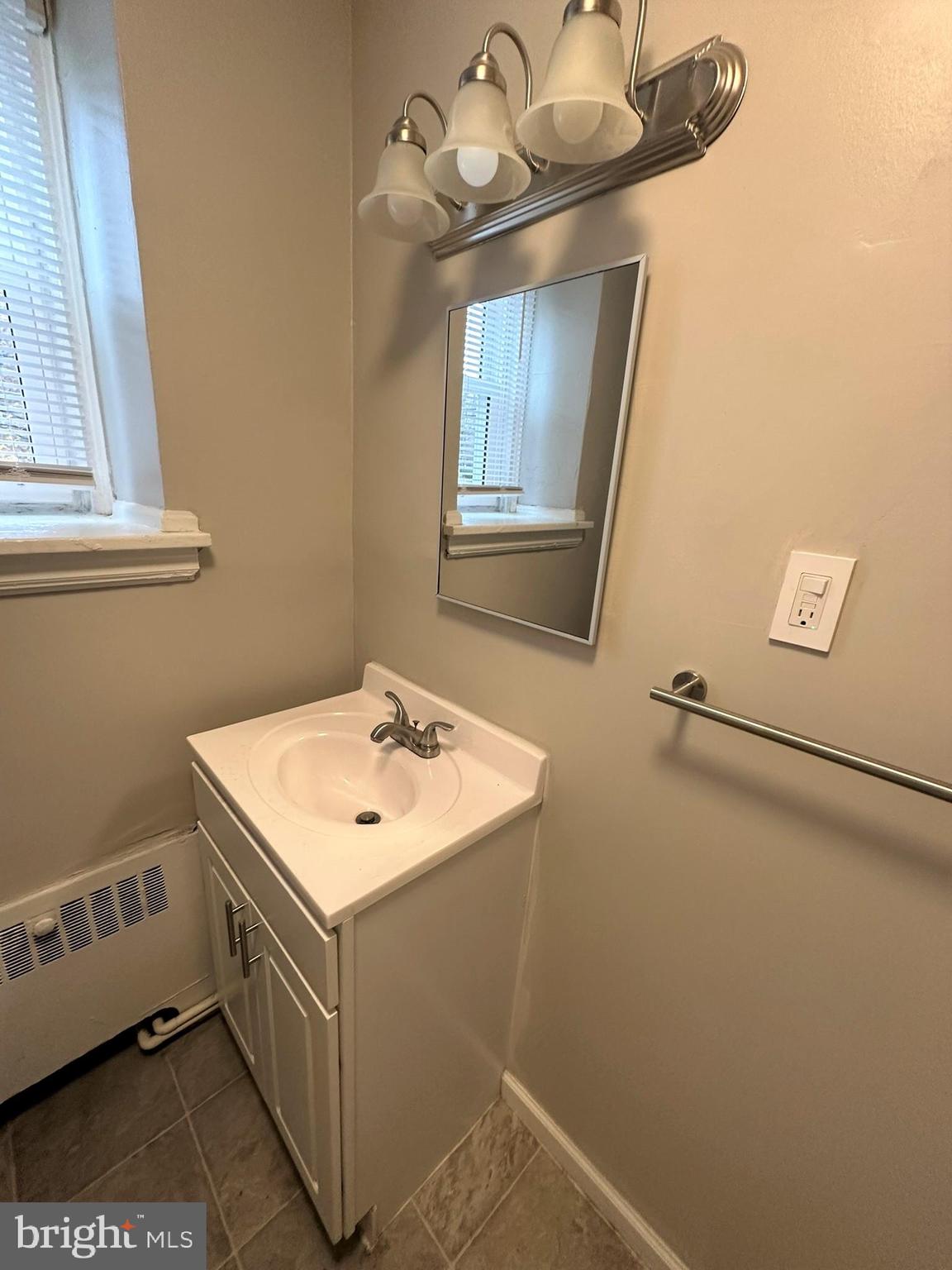 4927 Wynnefield Avenue, Unit 17A Philadelphia, PA 19131 - Photo 24 of 24 a bathroom with a sink a mirror and vanity