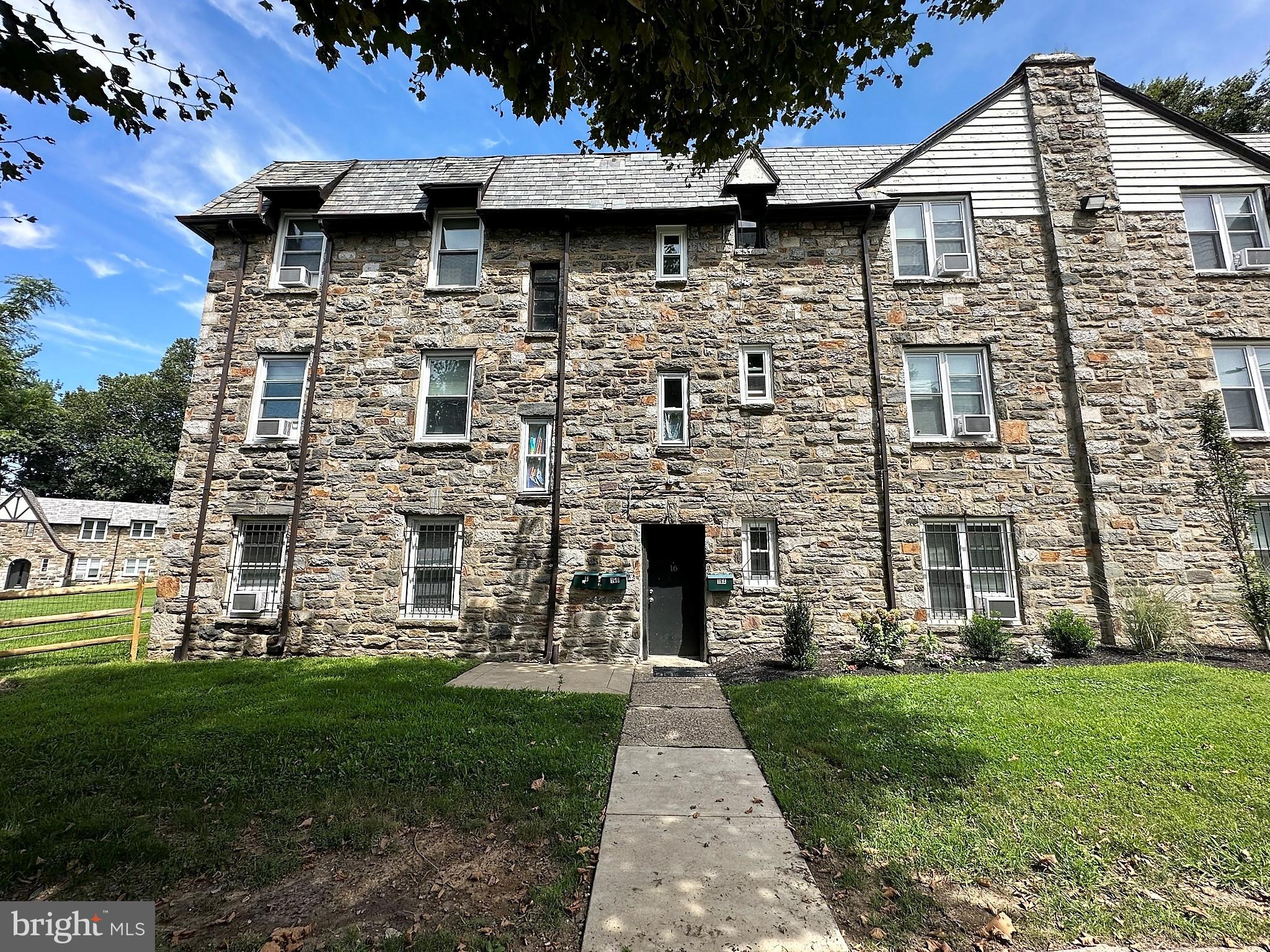 4927 Wynnefield Avenue, Unit 17A Philadelphia, PA 19131 - Photo 3 of 24 a front view of a house with a garden