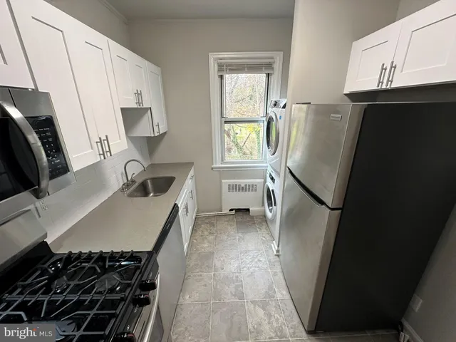 a kitchen with sink a refrigerator and a stove