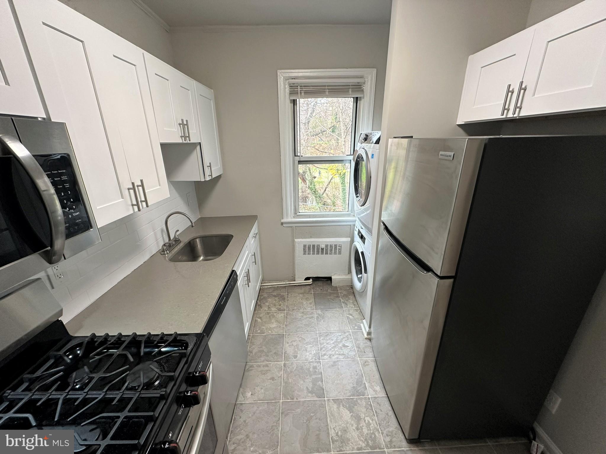 4927 Wynnefield Avenue, Unit 17A Philadelphia, PA 19131 - Photo 7 of 24 a kitchen with sink a refrigerator and a stove
