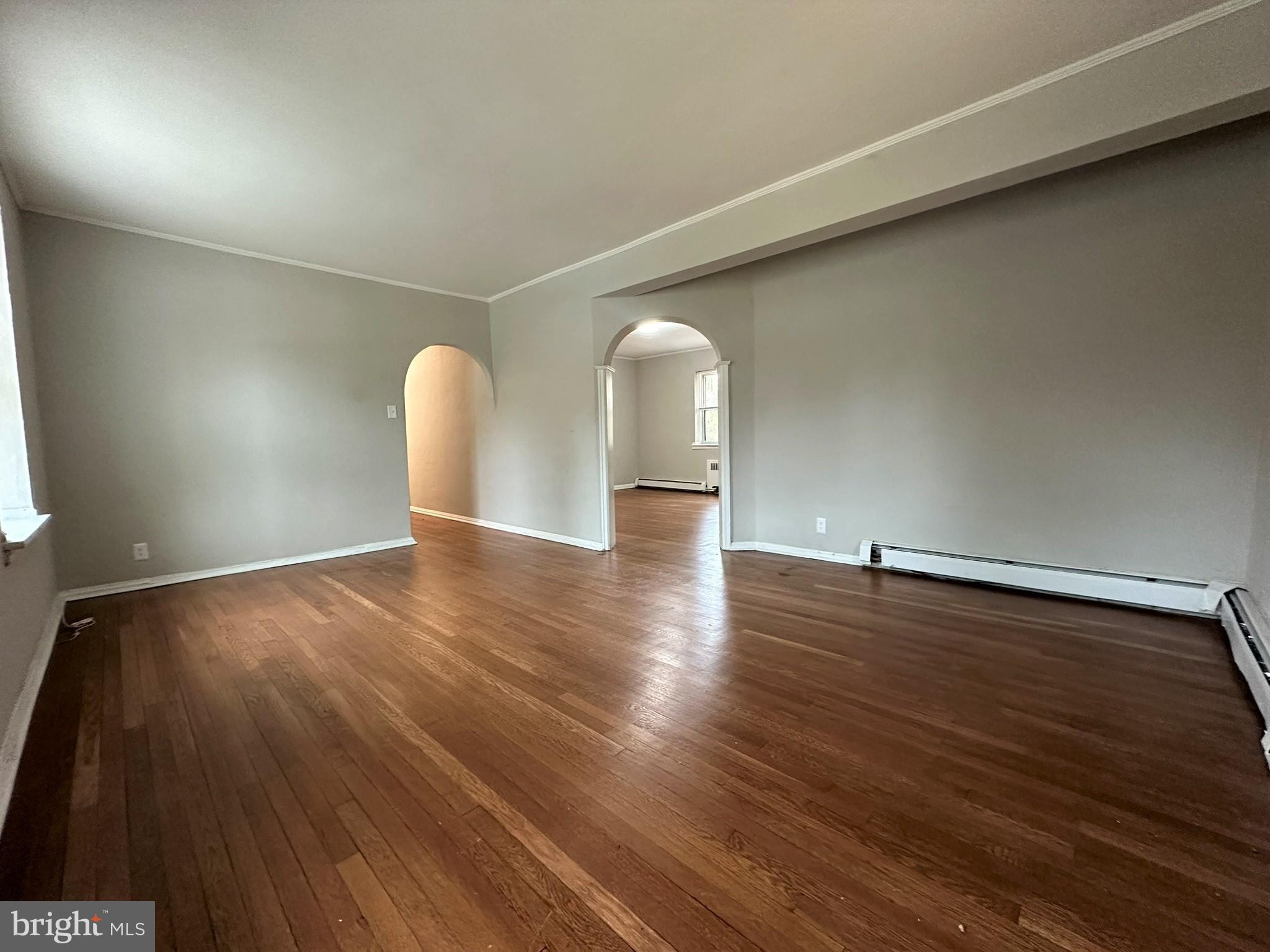 4927 Wynnefield Avenue, Unit 17A Philadelphia, PA 19131 - Photo 8 of 24 an empty room with wooden floor and windows