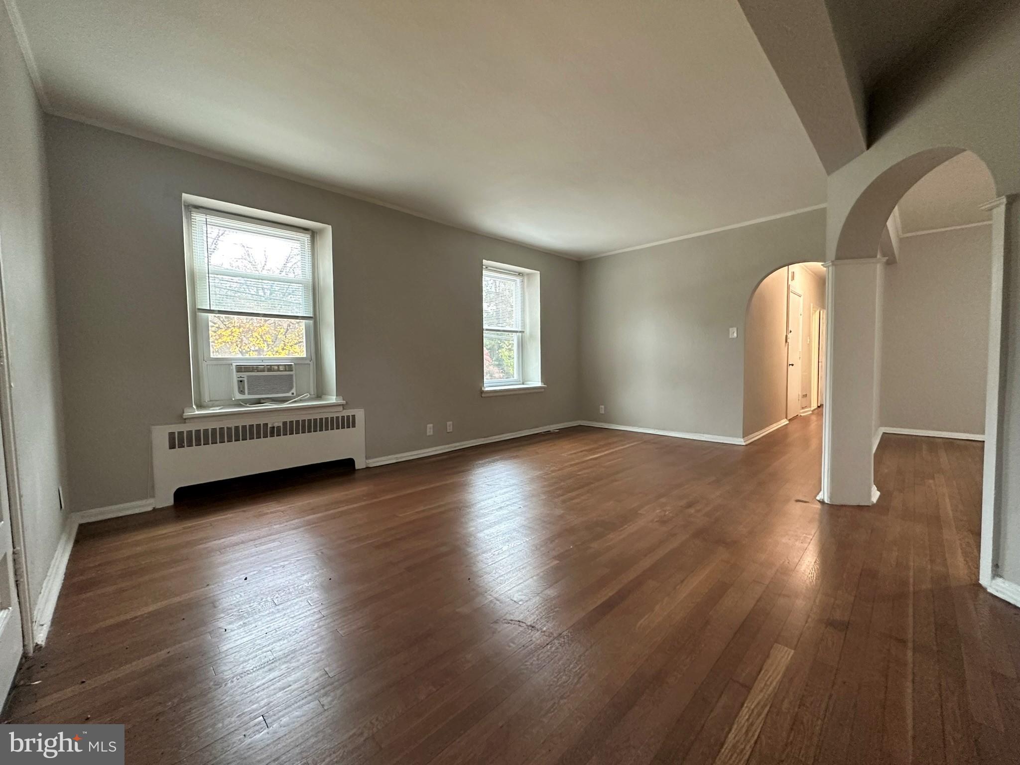 4927 Wynnefield Avenue, Unit 17A Philadelphia, PA 19131 - Photo 9 of 24 an empty room with wooden floor and windows