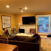a living room with furniture a fireplace and a flat screen tv