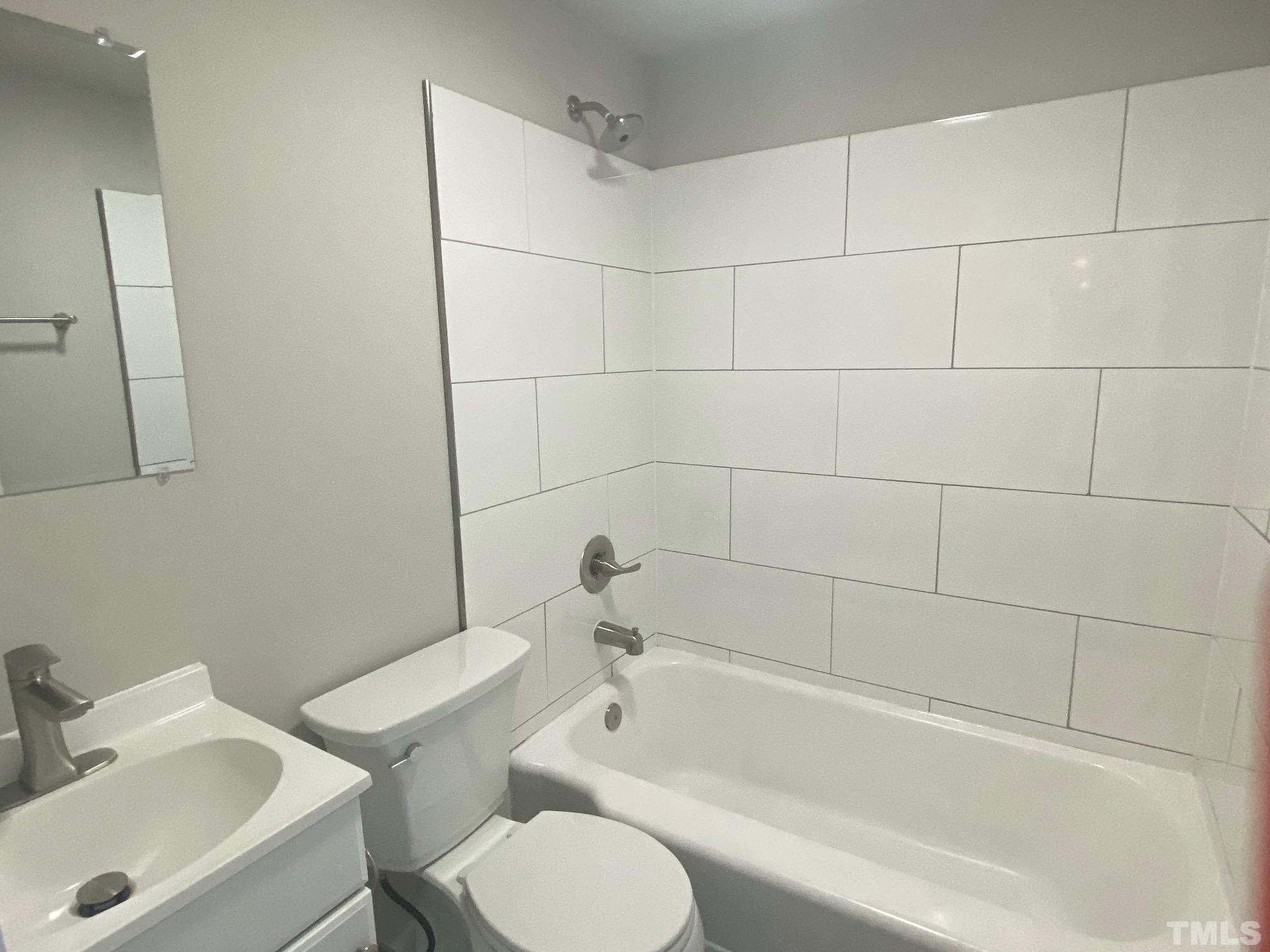 1501 Pender Street Raleigh, NC 27610 - Photo 8 of 8 a white bath tub sitting next to a white toilet and sink