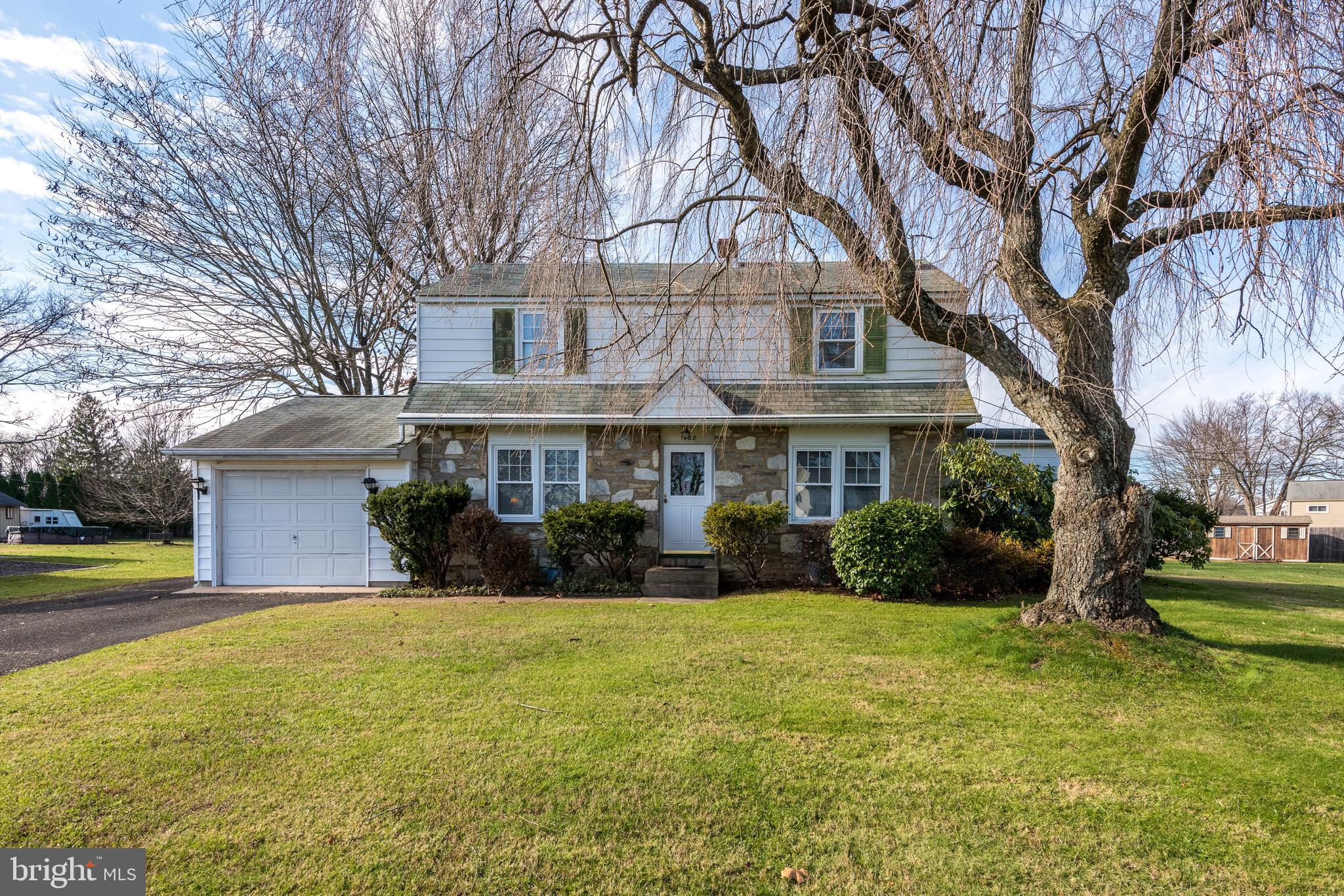 1228 Cambridge Road Warminster, PA 18974 - Photo 1 of 23 a front view of a house with garden and trees