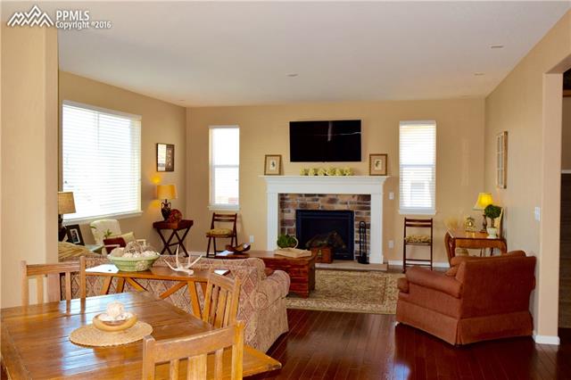 847 Spectrum Loop Colorado Springs, CO 80921 - Photo 11 of 22 Gorgeous gas fireplace with brick surround adds ambiance