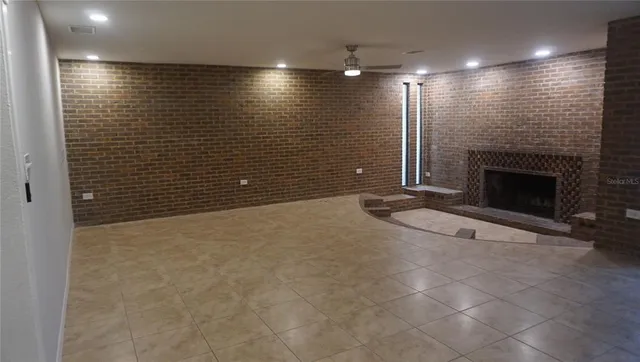 a view of an empty room with a fireplace