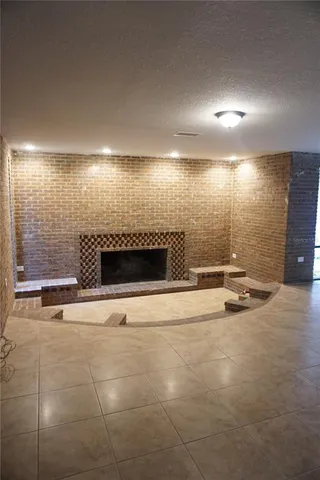 a view of an empty room with a fireplace