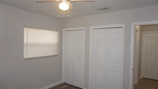 an empty room with closet area