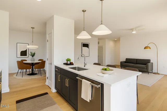 a kitchen that has a stove a table and chairs in it