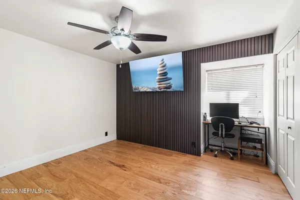 a view of a livingroom with workspace and a window