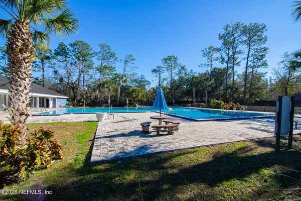 a view of a swimming pool with a yard