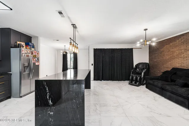 a living room with furniture a chandelier and a chandelier
