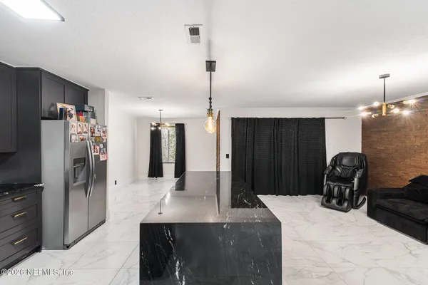 a kitchen with refrigerator and sink