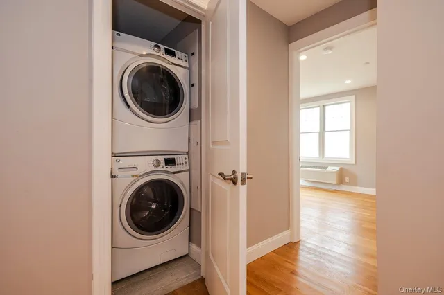a view of a hallway with washer and dryer