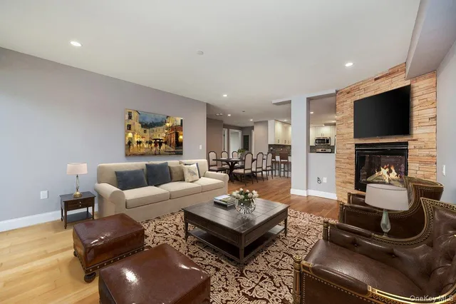 a living room with fireplace furniture and a flat screen tv