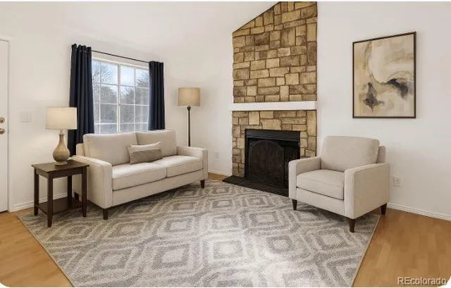 a living room with furniture and a fireplace