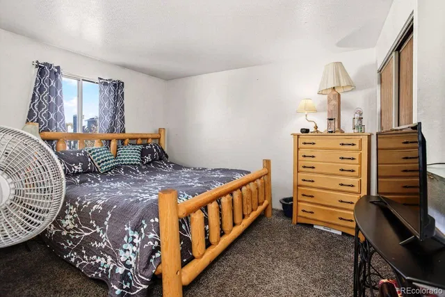 a bedroom with a bed and a cabinet