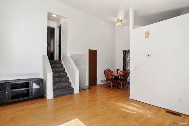 a view of a livingroom with furniture and stairs