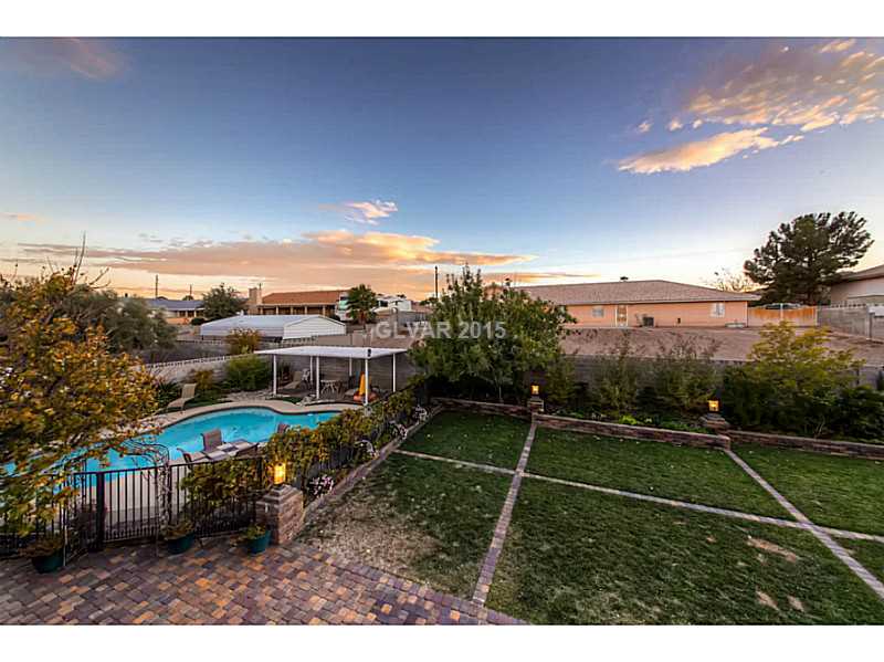 Exterior Back. An entertainer s dream, this back yard has a separately gated pool, play ground and much more.