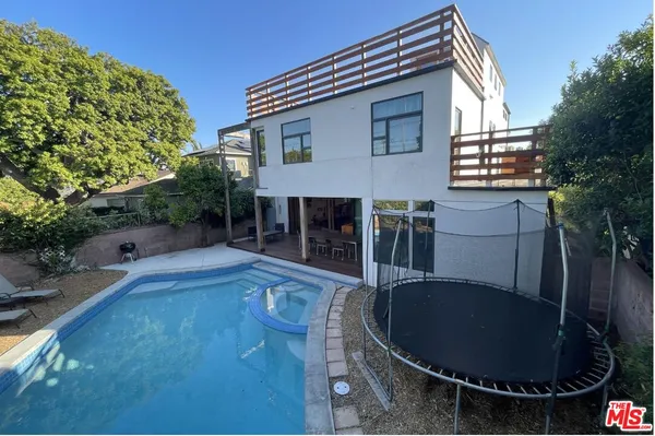 a backyard of a house with yard fire pit barbeque oven and outdoor seating